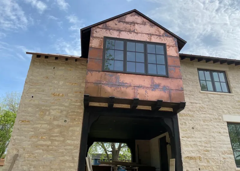 Copper metal panel facade on a stone building for Metal Roof Coating in Jericho