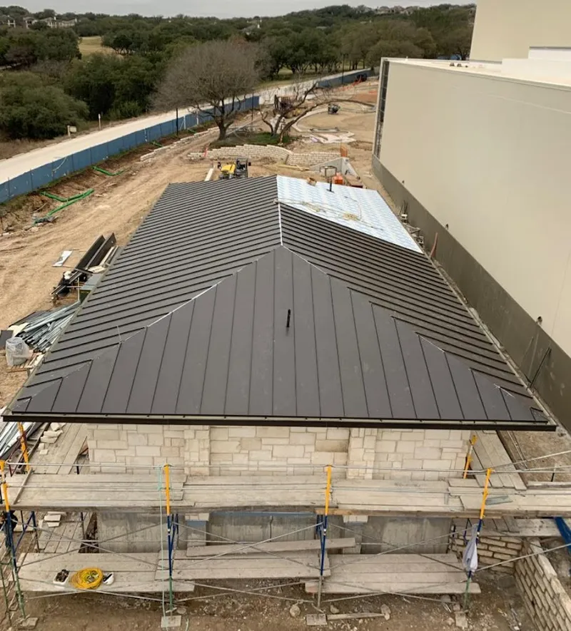 Metal roof new construction with scaffolding in Jericho